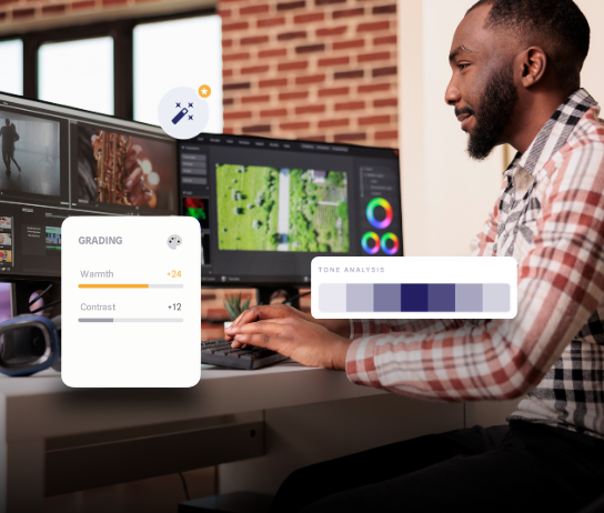 Photo editor at dual monitors with grading sliders and tone analysis UI