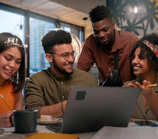 Team collaborating around a laptop