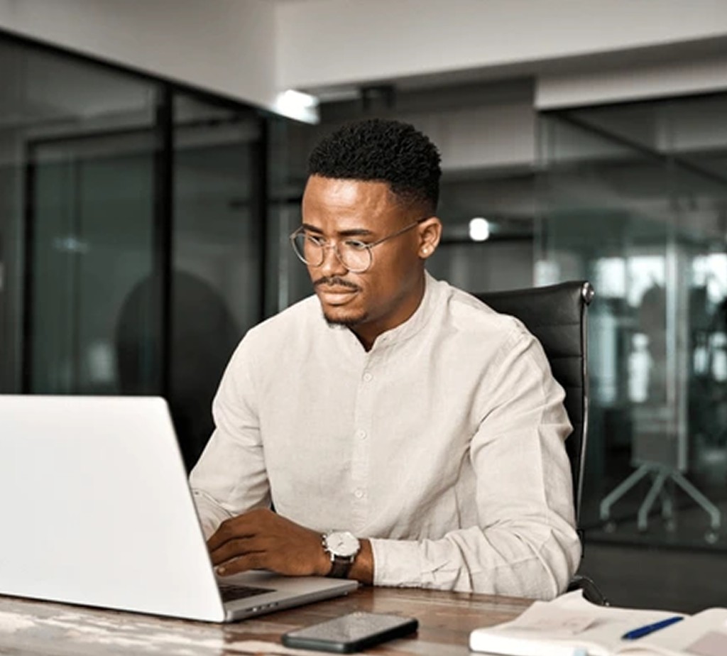 Professional focused on laptop in a modern office
