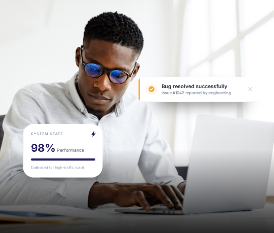 Developer at a laptop with system performance metrics and bug resolved toast