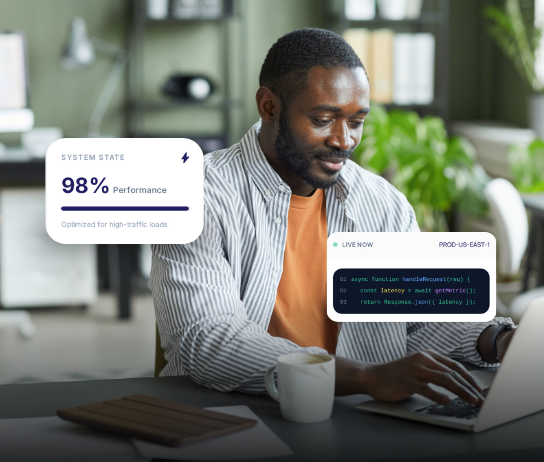 Developer at laptop with system state performance bar and live production code window